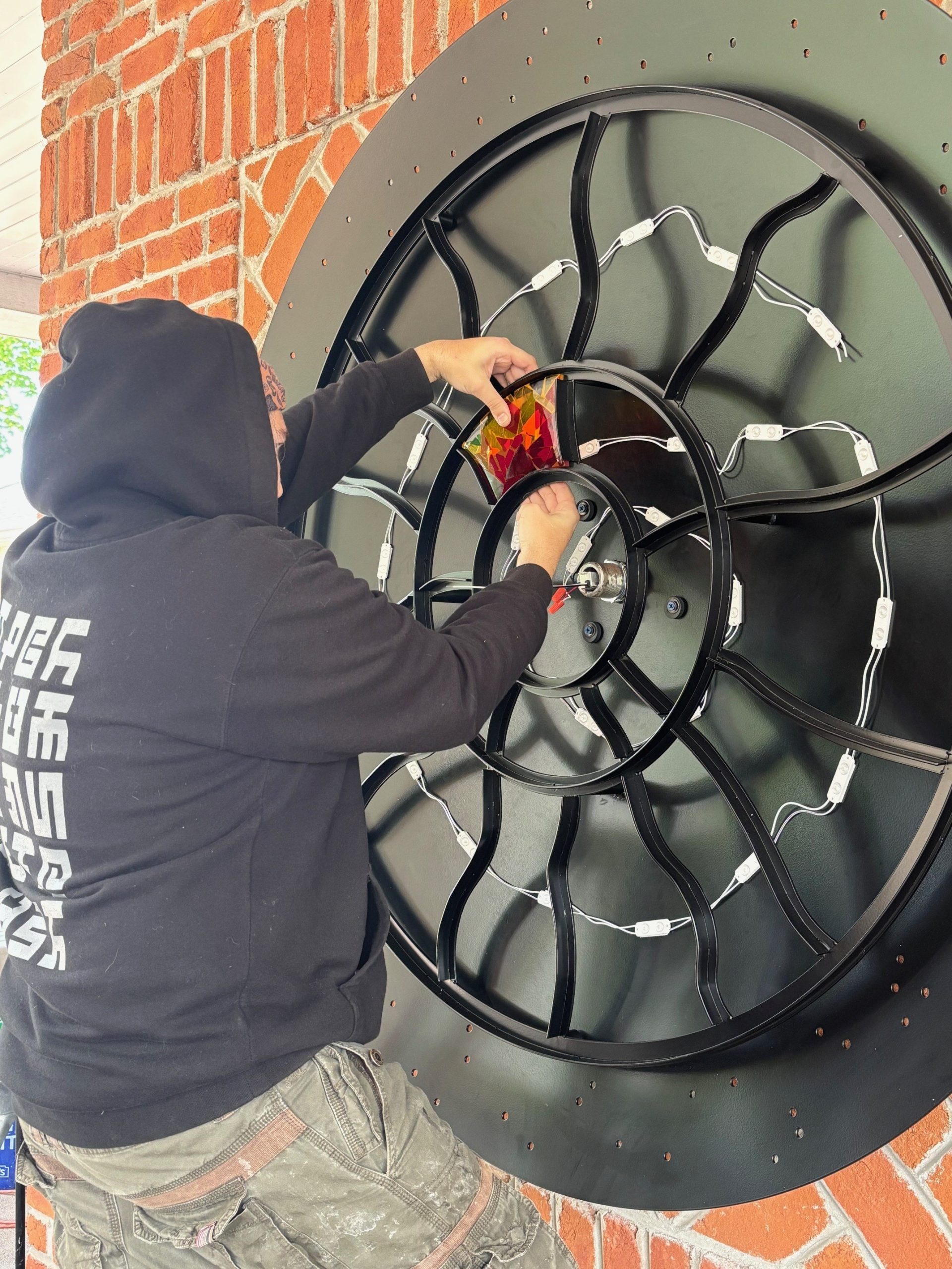 Artist Steve installing glass